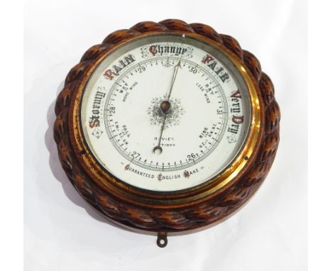 A carved oak aneroid barometer of ropetwist design, cased, white enamel dial, inscribed "Davis, Hastings" and a batch-driven 