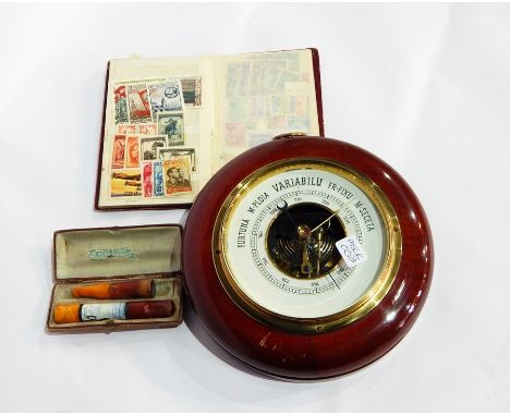 An aneroid barometer, a viewing magnifier, a small quantity of stamps, two cheroot holder and a small collection of European 