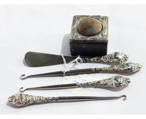 Three silver-handled button hooks, silver-handled shoe horn and an Edwardian silver-mounted pin box 