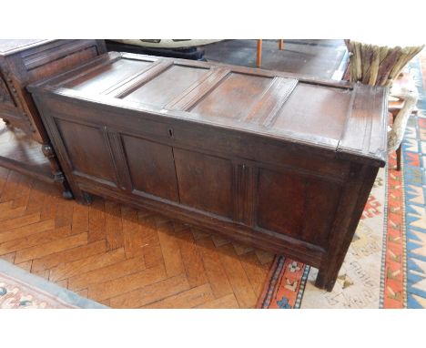 Early 18th century oak coffer, the four panel top above a plain frieze, the front panel initialled WB, raised on stile suppor
