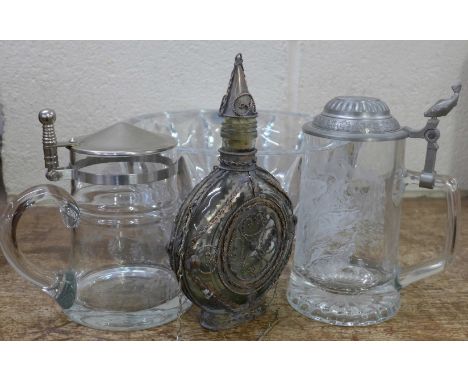 A Rogaska heavy cut glass bowl, two tankards and a metal covered flask