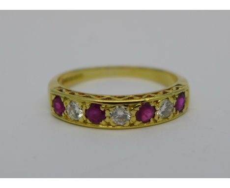 An 18ct gold, ruby and diamond seven stone ring, 0.3 carat diamond weight, 3.2g, Q