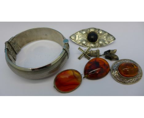 Jewellery including a bangle, amber brooches and a windmill brooch