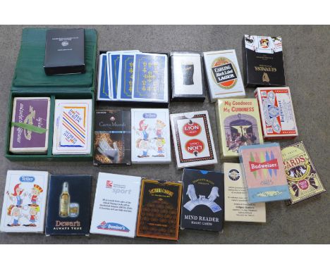 A collection of playing cards including advertising