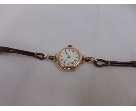 9ct gold cased ladies wrist watch with enamel dial and leather strap