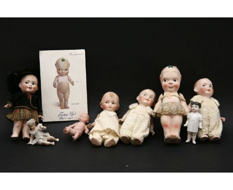 A Bisque fums-up doll, together with a postcard, four others and three babies figures, 15.5cm largest
