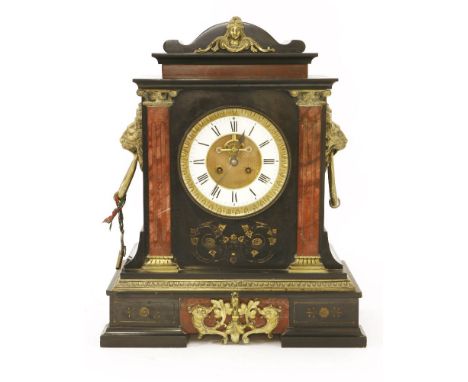 A Victorian marble mantel clock, with applied brass work, including lion's mask handles, rouge pillars and visible escapement