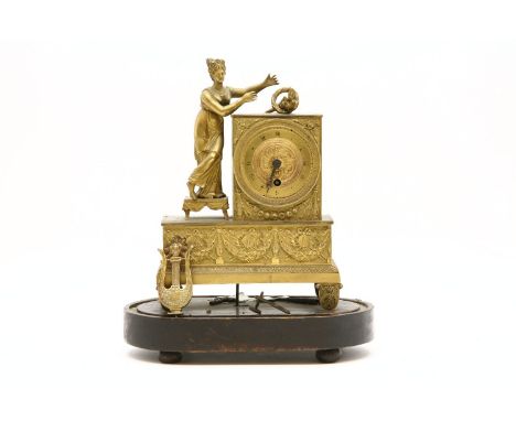 A 19th century French gilt metal mantel clock, the circular brass dial with Roman numerals and flanked by classical female fi