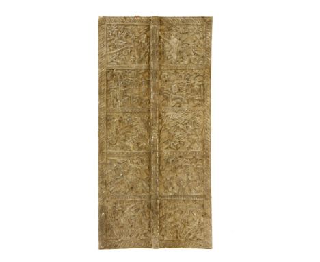 A South East Asian carved door panel, carved in relief with figures, 91cm x 185cm