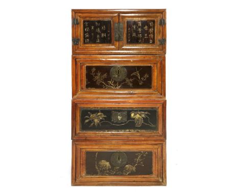 A four section Chinese cabinet,&nbsp;early 20th century, each section altered from a trunk with two handles, the door panels 