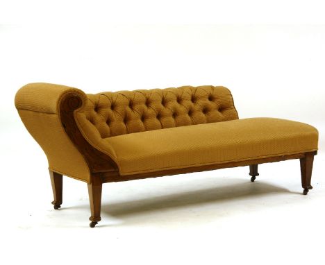 An Edwardian carved walnut chaise longue, with button back and scroll arm on square tapering supports, 167cm long