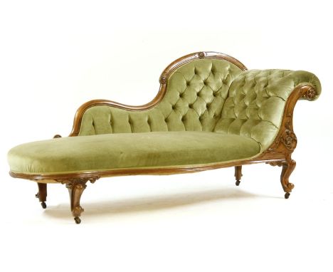 A Victorian walnut chaise longue, the button scroll arm above stuffover seat in green velour on cabriole supports, 200 x 70 x