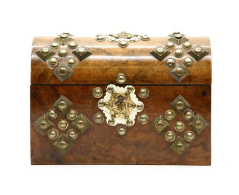 A Victorian figured walnut tea caddy, embellished with brass and studwork decoration, 23cm