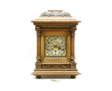 An early 20th century oak cased eight day mantel clock, with silver chapter ring and musical chime movement, 46cm high