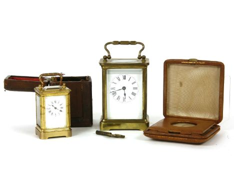 A four glass carriage clock, a cased four glass carriage clock and a travel clock