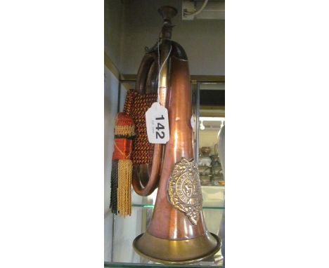 A copper and brass bugle with tassel