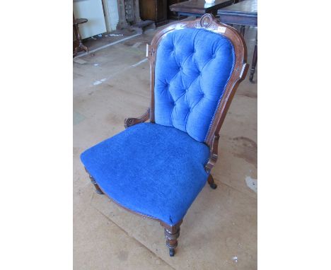 A Victorian button back chair on turned legs