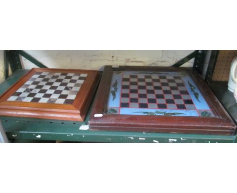 A framed reverse painted on glass chess board and a marble and treen chess board