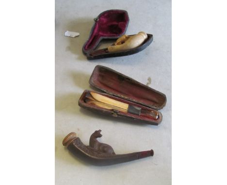 A tea caddy and three cased pipes