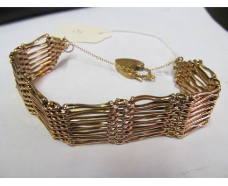 A gold gate bracelet unmarked some soldering to rings, 9ct gold padlock 23.1 gms