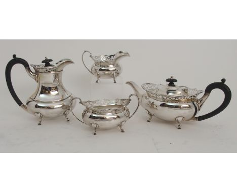 A FOUR PIECE SILVER TEA SERVICE by T &amp; H Crathmore Limited, Birmingham 1967, of oval shape with pierced gallery on four p