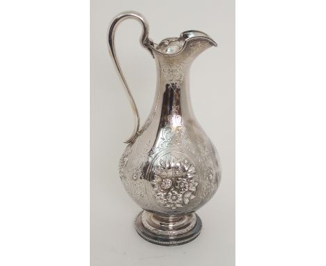 A VICTORIAN SILVER CLARET JUG by Harrison Brothers &amp; Howson, London 1873, of baluster form with slender neck and scrollin