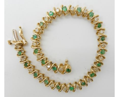 A 14K GOLD EMERALD AND DIAMOND LINE BRACELET set with estimated approx 0.44cts of brilliant cut diamonds set alternately with