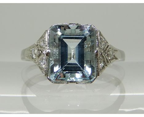 A PLATINUM AQUAMARINE AND DIAMOND RING the step cut aquamarine measures approx 8.6mm x 6.9mm x 5.1mm, with diamond accents se