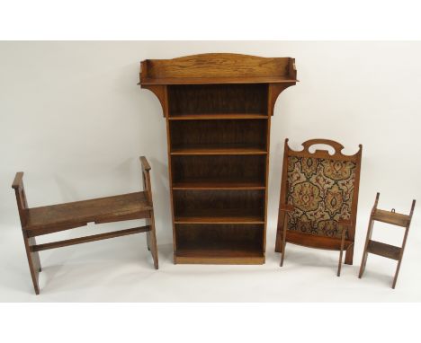 AN OAK ARTS AND CRAFTS OPEN BOOKCASE the three quarter shaped cornice above five shelves, 132cm high x 91cm wide x 20cm deep,