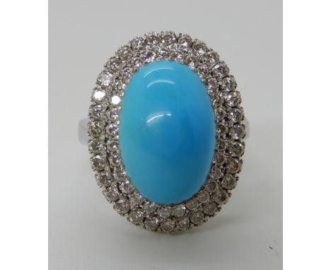 AN 18CT WHITE GOLD TURQUOISE AND DIAMOND RING the central turquoise measures approx 14.7mm x 9.7mm x 6mm and surrounded with 