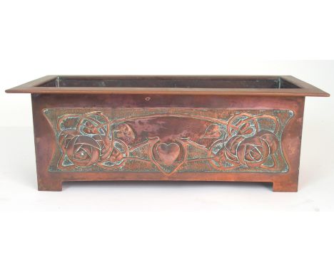 A SCOTTISH SCHOOL COPPER PLANTER in the style of Margaret Gilmour, the front and back decorated with Glasgow roses flanking a