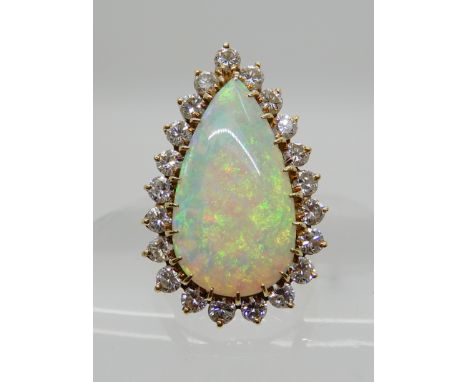 AN 18CT GOLD OPAL AND DIAMOND CLUSTER RING pear shaped opal approx 21.5mm x 11.8mm x 3mm, surrounded with estimated approx 1.