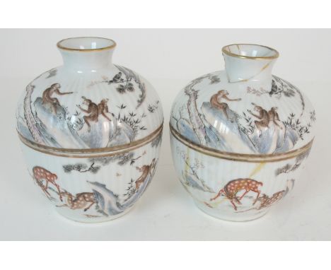 A PAIR OF CHINESE FLUTED COVERED BOWLS each painted with deer, monkeys, birds and butterflies amongst pine trees issuing from