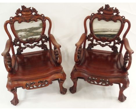 A PAIR OF CHINESE HARDWOOD ARMCHAIRS the vase shaped backs inset with marble and within carved frames with grotesque animals,