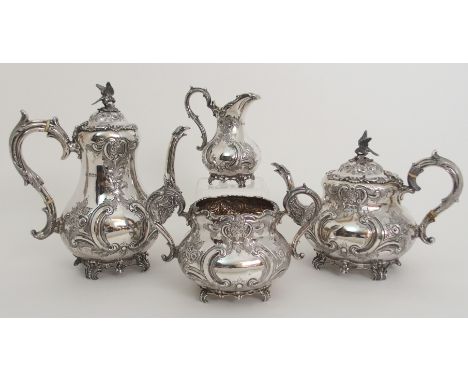 A FOUR PIECE SILVER TEA AND COFFEE SERVICE by Martin Hall & Company, Sheffield 1898, of baluster shape with foliate embossed 