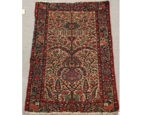 A LIGHT GROUND TREE OF LIFE RUG the branches having various leaves and fruits, the blue border having birds on branches, 197c