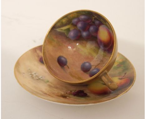 A ROYAL WORCESTER FRUIT PAINTED CUP AND SAUCER the saucer with apples, cherries and blackcurrants, signed Ricketts and the cu