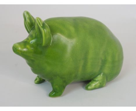A SMALL WEMYSS WARE PIG circa 1900, in a green glaze, impressed mark WEMYSS WARE/ R. H. &amp; S, 16cm long Condition Report: 