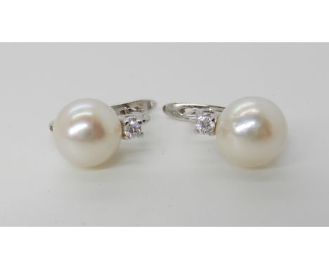 A PAIR OF WHITE METAL PEARL AND DIAMOND EARRINGS with continental loop fittings, pearls approx 9.2mm, with diamond accents at