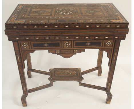 A SYRIAN DAMASCUS INLAID GAMES TABLE CIRCA 1910 with multiple geometric and asymmetric inlays with various woods and mother o