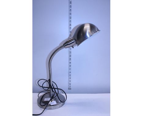 A modern flexible brushed steel desk lamp 