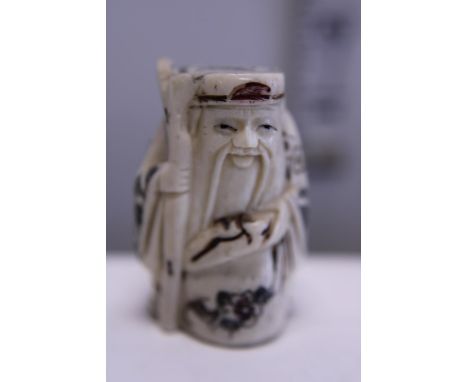 A hand carved Netsuke, signed to base 
