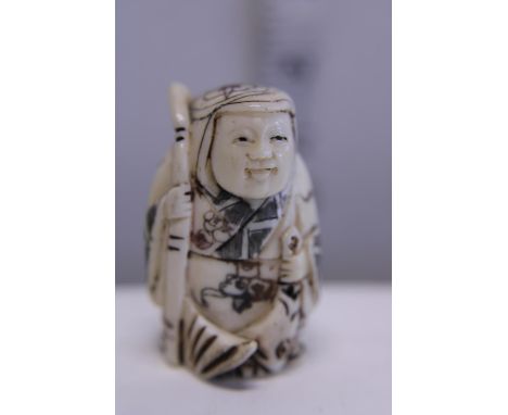 A hand carved Netsuke, signed to base 