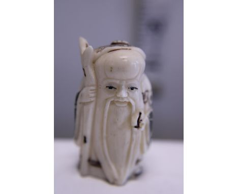 A hand carved Netsuke, signed to base 