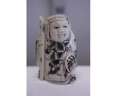 A hand carved Netsuke, signed to base 