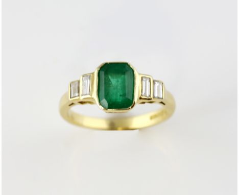 Emerald and diamond ring, step cut emerald, estimated weight 1.21 carats, set with four baguette cut diamonds 0.16 carats, mo