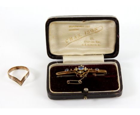 Edwardian seed pearl and blue paste brooch and a tri coloured wishbone ring, size T, both stamped 9 ct PROVENANCE: Sold on be