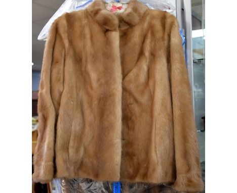 Three quarter length mink coat and a blonde mink jacket.  