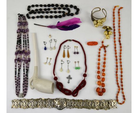 Mixed group of items including an amber bead necklace, other vintage costume jewellery a panel belt and  a clay pipe .  CONDI