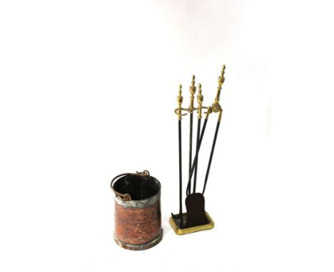 A set of three brass fire irons and stand and a copper swing-handled bucket CONDITION REPORT: The stand is approximately 82cm